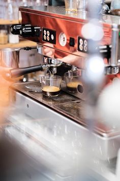 an espresso machine with two cups on it