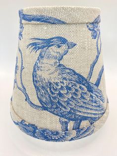 a blue and white lamp shade with a bird on it