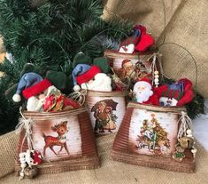 four christmas baskets with santa claus and other holiday decorations on top of burlap