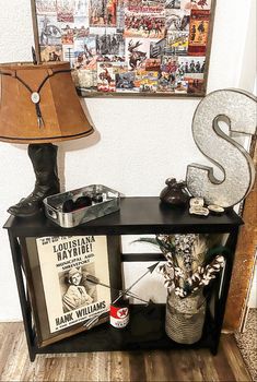 a shelf with some items on it and a lamp in front of the letter s