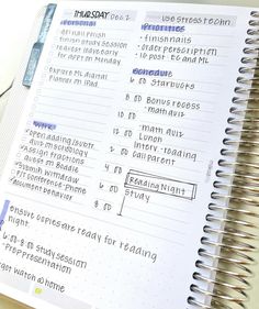 a close up of an open notebook with writing on the page and a computer mouse next to it