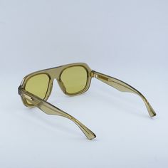 Welcome to Ossa Frames, where we bring you the latest in designer eyewear from top brands like Bottega Veneta. Introducing the Bottega Veneta BV1217S 003 Yellow Crystal/Gold/Mustard aviator sunglasses, a stunning piece that exudes luxury and style. These sleek sunglasses feature a frame color of Yellow Crystal, giving them a unique and eye-catching look that is sure to turn heads. The gold accents on the temples add a touch of elegance, while the Mustard lenses provide a pop of color that is per Sleek Sunglasses, Designer Eyewear, Eyewear Design, Aviator Sunglasses, Gold Accents, Bottega Veneta, Mustard, Color Pop, Lenses