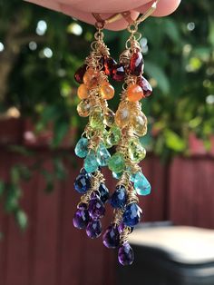 "🌈 💎 A lovely cascade of faceted teardrop gemstones! These are made up of genuine Mozambique and Mandarin garnets, citrine, peridot, sky-blue apatite, kyanite and African amethysts. Wrapped in 14K gold-filled wire, and suspended beneath gold-filled leverback earwires, these beauties are 2.75\" in length. Lightweight and stunning in the light! Your earrings will be gift-boxed to protect the stones, and gift-wrapping is available upon request. Thanks for checking out my shop!" Rainbow Waterfall, Waterfall Earrings, Purple Quartz, Rainbow Jewelry, Bright Rainbow, Beaded Drop Earrings, Rainbow Earrings, Blue Apatite, Gold Filled Earrings