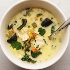 a white bowl filled with soup on top of a table