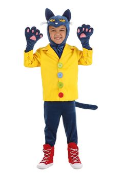 a little boy in a yellow jacket and blue pants is wearing a cat costume with his hands up