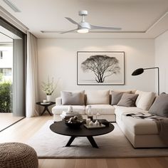 a living room filled with furniture and a ceiling fan