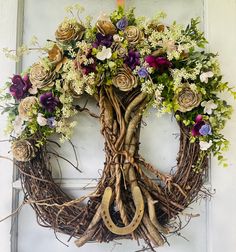 a wreath made out of branches and flowers