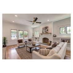 a living room filled with furniture and a fire place in the middle of a room