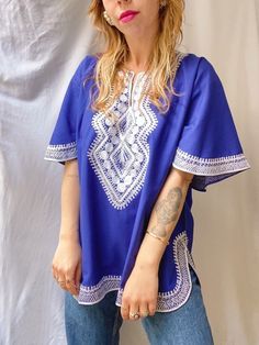 PLEASE NOTE new orders will be shipped after 13th of March due to holiday 💝 please enjoy 15% off the whole collection 💕   Vintage embroidered top, in a bright cobalt blue color. The top is made of pure cotton, with added white embroidery. In a good vintage condition. Fits up to size XL, check measurements to be sure. Model is a size S/M for reference.  size L / XL - measured flat - armpit to armpit: 60cm shoulder to shoulder: 49cm length: 68cm Please compare it with a garment you already own to be sure :) Thank you for visiting my shop <3  { Please read this before shopping } -  Please note that you are buying a vintage garment, garments will not be as new but I check each item very well. Major flaws are always noted in description. Everything is steamed before shipping - All sales are f Blue Folk Top With Geometric Embroidery, Blue Folk Style Short Sleeve Blouse, Blue Folk Style Summer Blouse, Blue Short Sleeve Folk Blouse, Indigo Cotton Traditional Tops, Traditional Blue Short Sleeve Blouse, Traditional Indigo Cotton Top, Blue Tunic Top With Floral Embroidery, Blue Embroidered Folk Top