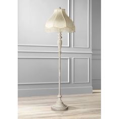 a floor lamp with a white shade on it