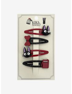 three black and red hair clips with cats on them in the shape of combs