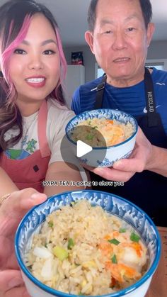 two people holding bowls of food and smiling at the camera