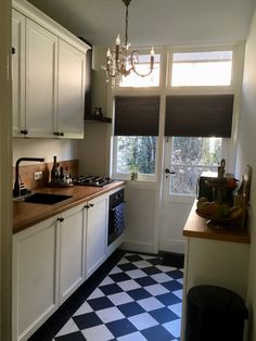 a black and white checkered floor in a kitchen