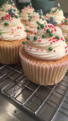 cupcakes with white frosting and green sprinkles