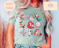 a woman with blonde hair wearing a t - shirt that has mermaids on it