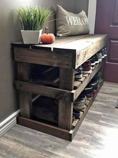 a bench made out of wooden pallets with shoes on it and a potted plant