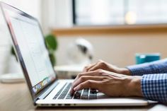 a person using a laptop computer on a desk