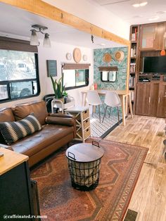 a living room filled with furniture and a flat screen tv mounted to the side of a wall