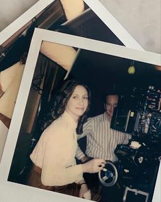 an old photo of two people sitting at a table