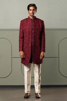 Wine sherwani with all-over intricate embroidery in chevron pattern, concealed placket and full sleeves. Comes with white trousers.
Component: 2
Embroidered
Neckline: Band Collar
Sleeve Length: Full
Fabric: Sherwani: Silk; Trousers: Suiting
Color: Maroon
Note: The kurta worn by the model is not for sale - Aza Fashions Maroon Sherwani, Indo Western Outfits For Men, Kerala Engagement Dress, Embroidered Sherwani, Sherwani Groom, Wedding Outfit Men, Indian Men Fashion, Jacquard Jacket, New Address