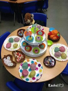 a table topped with lots of cupcakes and donuts