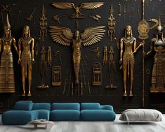 a living room filled with lots of gold statues on the wall next to a blue couch