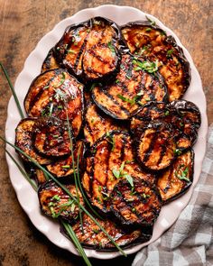 grilled eggplant on a plate with herbs