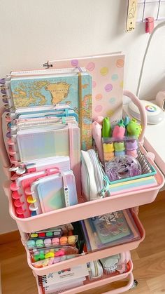 a pink cart filled with lots of crafting supplies