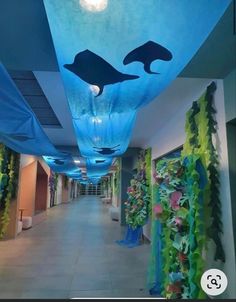 the hallway is decorated with blue and green seaweed, dolphins and other marine creatures