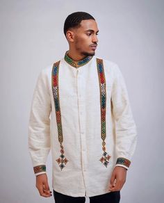 This Habesha shirt for men is the perfect choice for those who want to combine traditional elegance with modern simplicity. Made with high-quality fabric and designed with intricate details, this shirt is a true work of art. The shirt features a beautiful Tilf design that adds a touch of traditional charm to the modern silhouette. The shirt is designed to fit comfortably and flatteringly, with a classic cut and a simple yet stylish design. It is perfect for formal occasions such as weddings, cul Boubou Styles For Men, Habesha Libs For Men, Ethiopian Traditional Clothes Men, Habesha Dress For Men, Habesha Clothes For Men, Ceremonial Long Sleeve Habesha Kemis With Traditional Patterns, Ceremonial Long Sleeve Habesha Kemis For Eid, Festive Long Sleeve Habesha Kemis With Traditional Patterns, Festive Long Sleeve Fitted Habesha Kemis