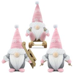 three small gnomes with pink hats and sled