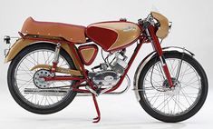 an old style motorcycle is shown on a white background with red trim and spokes