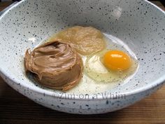 two eggs and chocolate in a white bowl