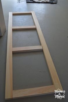 an unfinished frame is sitting on the floor