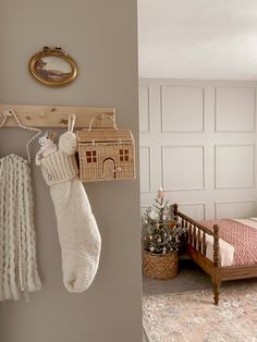 a bedroom with a bed, christmas tree and stockings hanging from the hooks on the wall