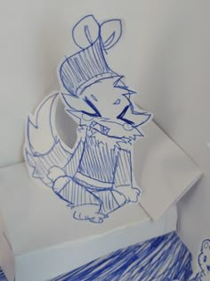 a drawing of a cartoon character on top of a piece of paper with blue ink