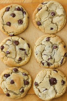 six chocolate chip cookies on a cutting board