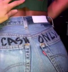 the back of someones jeans with cash only written on them and in their pockets