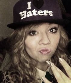 a woman wearing a hat with i haters written on it