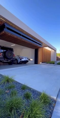 a car is parked in front of a modern house with an attached carport and garage