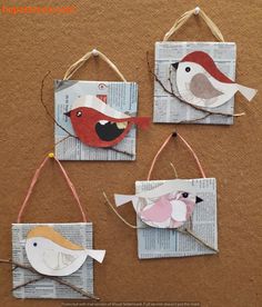 three paper birds are hanging from twine