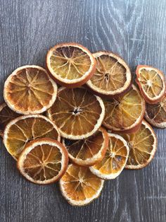 an arrangement of oranges cut in half on a wooden table