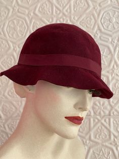 Adorable ultra soft deep maroon gadabout cloche type vintage hat. In good vintage condition. Ribbon needs reattached in places. Shows age but is still vibrant and beautiful. Tags Measures Please message me with questions before purchasing All sales are final and ship quickly from our Vermont shop. Find us on insta @anasclosetfullofcolor Thankyou! Fitted Solid Cloche Hat, Fitted Solid Color Cloche Hat, Vintage Cloche Hat, Vintage Cloche Hat With Curved Brim For Fall, Vintage Red Hat For Fall, Vintage Cloche Hat For Fall, Vintage Adjustable Cloche Hat For Fall, Vintage Bucket Hat For Fall, Winter Vintage Bucket Hat With Curved Brim