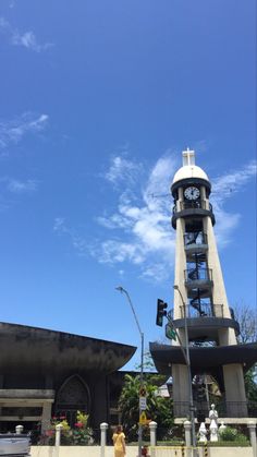 a tall clock tower sitting next to a traffic light