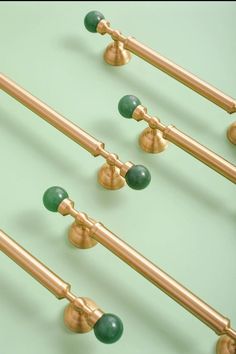 four green and gold knobs on the handles of some doors