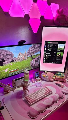 two computer monitors sitting on top of a desk next to a keyboard and monitor screen