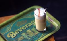 a drink sitting on top of a green tray