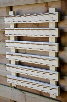 a close up of a wooden fence with slats attached to the boards and nails