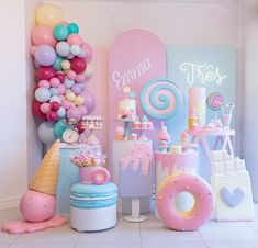 an ice cream themed birthday party with pastel colors, balloons and candy bar decorations