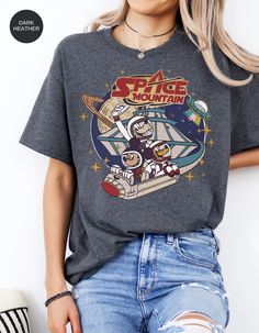 a woman wearing a space mountain t - shirt with an image of the cartoon characters on it